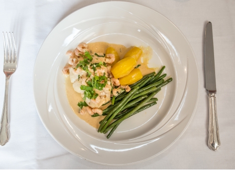 Baked Fillet of Hake with Prawns, Cream Curry and Coriander Sauce